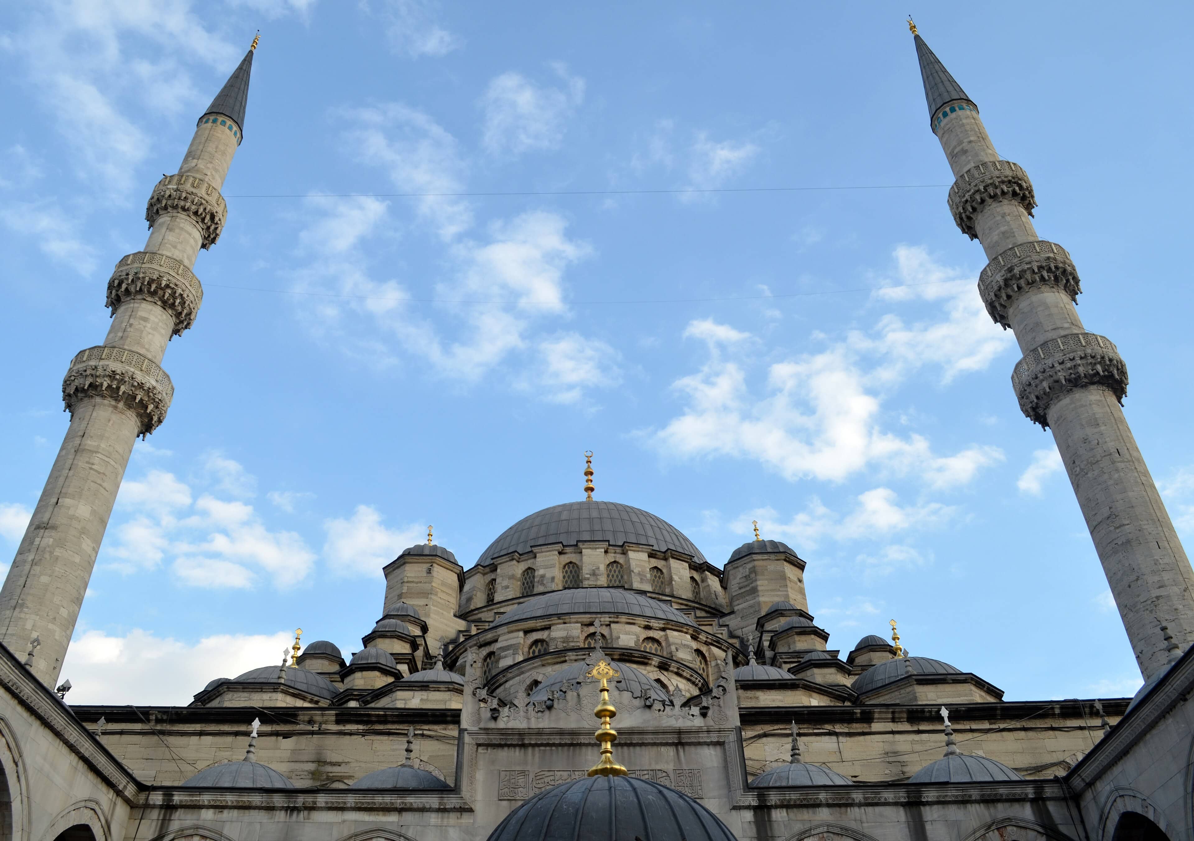 The New Mosque in Istanbul, its domes and slender minarets rising against a bright blue sky