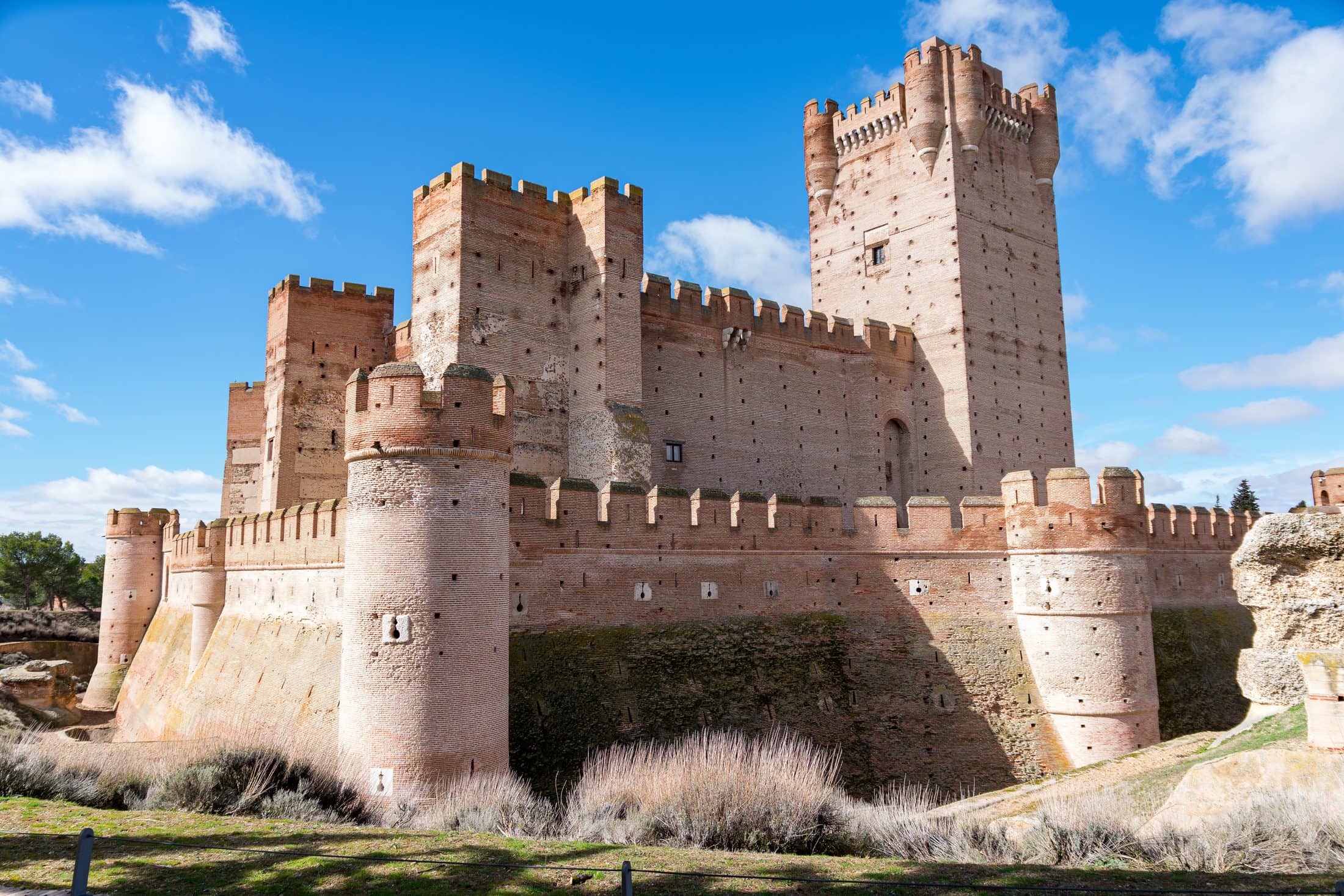 The Castle of La Mota under the sunlight and a blue sky at daytime in Medina del Campo, Spain